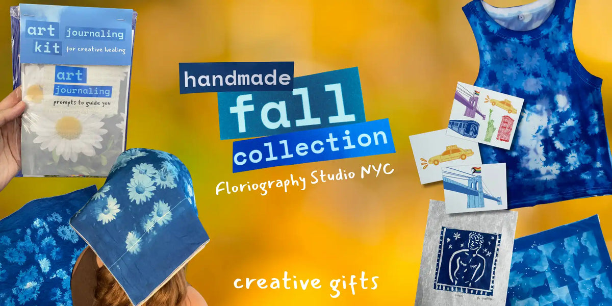 A promotional collage for a handmade fall collection featuring blue indigo-dyed garments and art journaling kits. Visible items include a blue tie-dye tank top, a blue patterned hat, a blue art journaling kit package held by a hand, a blue art journaling kit cap, and several small printed cards or labels on a bright yellow-orange gradient background.